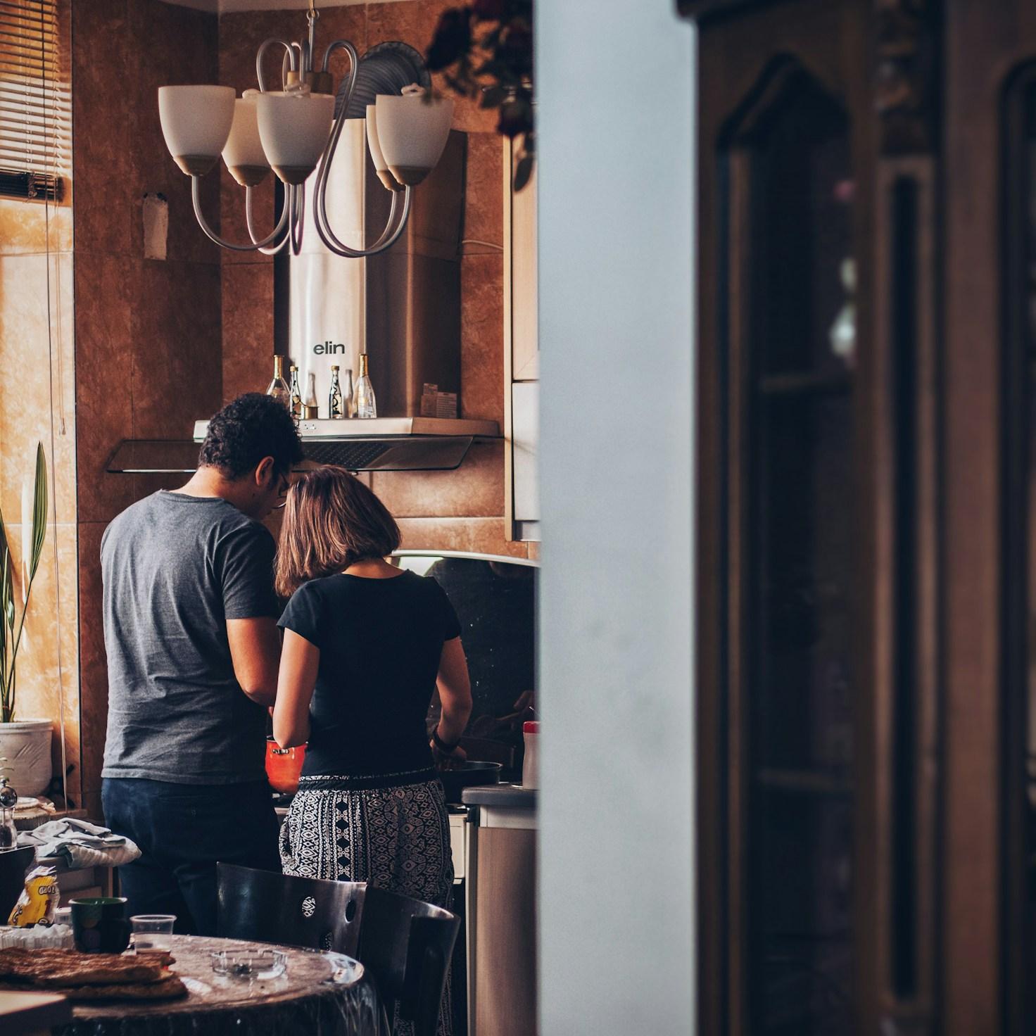 Community members collaborating in a modern kitchen space, sharing recipes and cooking techniques